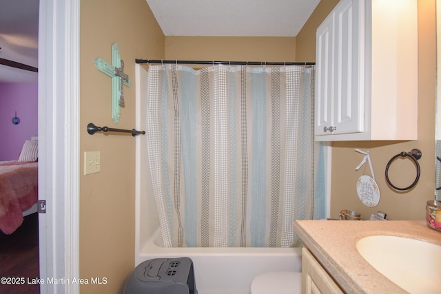 bathroom with vanity, toilet, and shower / tub combo with curtain