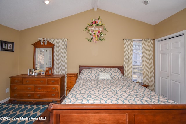 bedroom with lofted ceiling with beams and baseboards