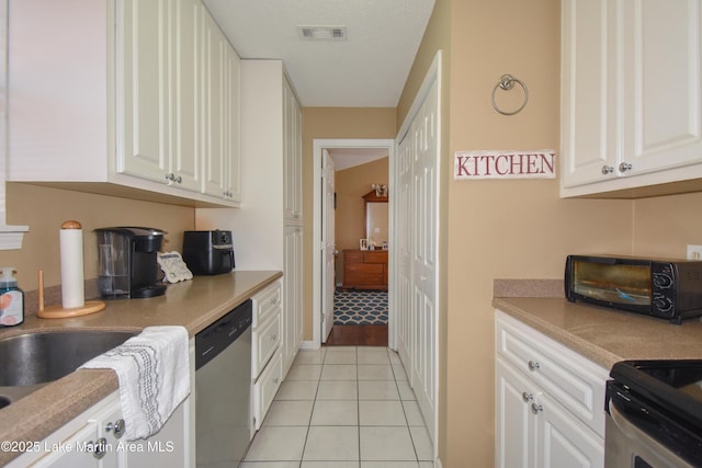 kitchen with visible vents, light countertops, light tile patterned floors, white cabinets, and stainless steel appliances