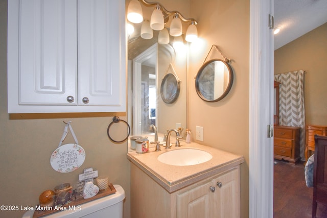 half bath featuring toilet and vanity