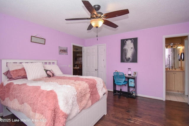 bedroom with a ceiling fan, a textured ceiling, wood finished floors, a closet, and baseboards