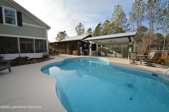 view of pool with a gazebo, a sunroom, an outdoor hangout area, and a patio area