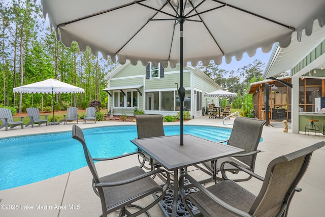 24 Hideaway Cir, Jacksons Gap, AL 36861 - pool featuring a sunroom, a patio area, and outdoor dining space