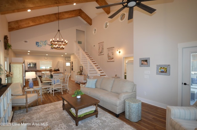 living room with hardwood / wood-style flooring, ceiling fan with notable chandelier, high vaulted ceiling, and beamed ceiling