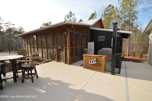 view of patio / terrace featuring area for grilling and a sunroom