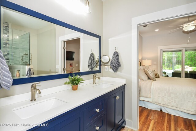 24 Hideaway Cir, Jacksons Gap, AL 36861 - full bath with ensuite bathroom, a sink, a ceiling fan, and wood finished floors