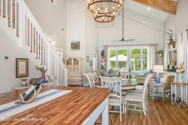 24 Hideaway Cir, Jacksons Gap, AL 36861 - dining area with wood finished floors, high vaulted ceiling, beamed ceiling, ceiling fan with notable chandelier, and stairs