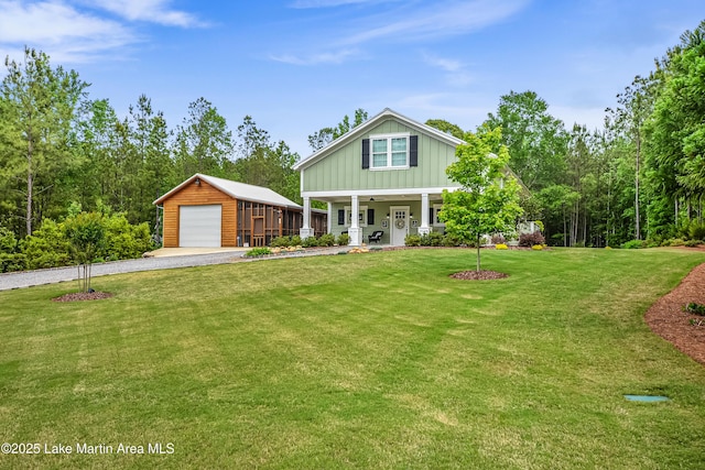 24 Hideaway Cir, Jacksons Gap, AL 36861 - view of front facade featuring board and batten siding, an outbuilding, a front yard, and a garage