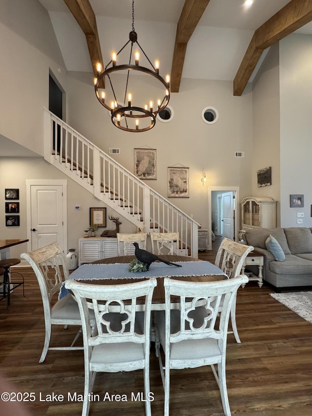 dining room with a high ceiling, dark hardwood / wood-style floors, a chandelier, and beamed ceiling