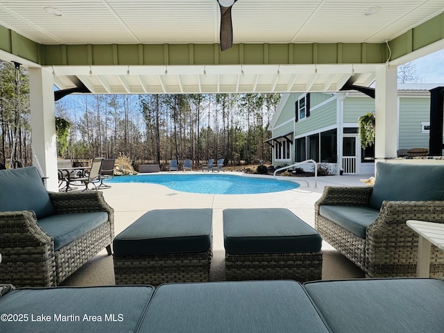 view of pool with a patio and a sunroom