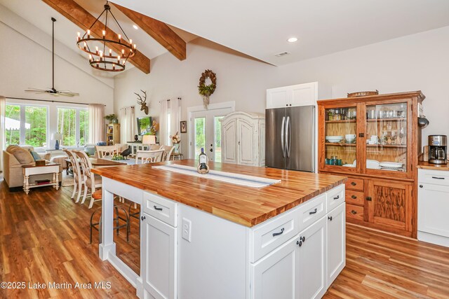 24 Hideaway Cir, Jacksons Gap, AL 36861 - kitchen with wood counters, freestanding refrigerator, open floor plan, vaulted ceiling with beams, and light wood-type flooring