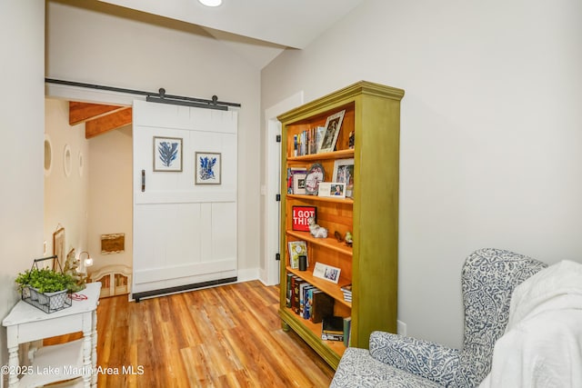 24 Hideaway Cir, Jacksons Gap, AL 36861 - living area with a barn door, wood finished floors, and vaulted ceiling