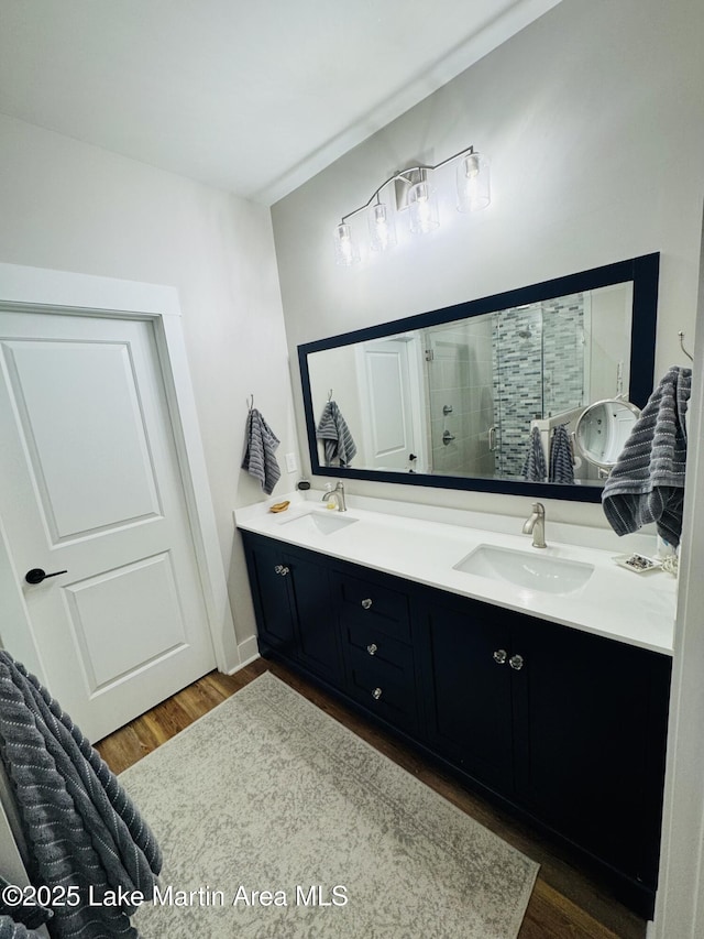 bathroom with vanity, a shower with door, and hardwood / wood-style floors