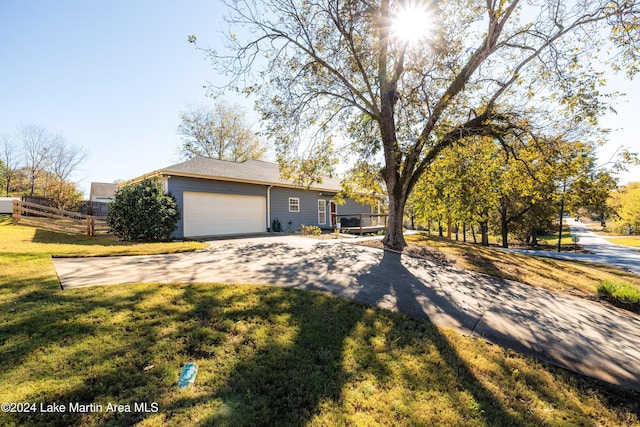 ranch-style home featuring a front lawn and a garage