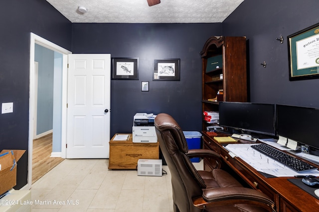 office space with light wood-type flooring and a textured ceiling