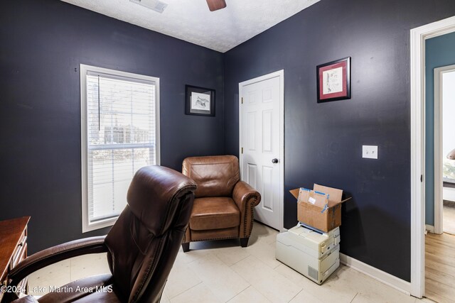 office featuring ceiling fan and a textured ceiling