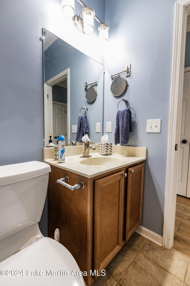 bathroom with tile patterned floors, vanity, and toilet