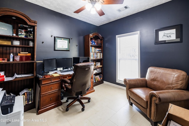 home office featuring a textured ceiling and ceiling fan