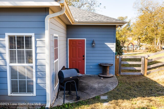 entrance to property with a yard and a patio