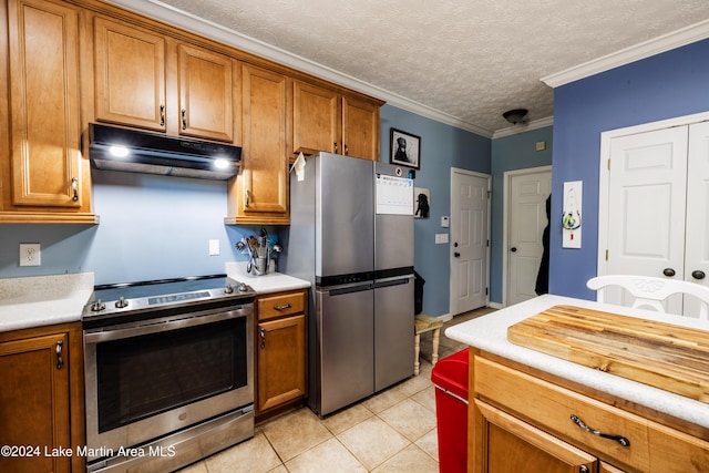 kitchen with appliances with stainless steel finishes, a textured ceiling, crown molding, and light tile patterned flooring