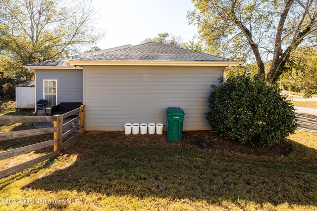 view of side of home featuring a lawn