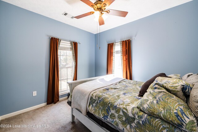 carpeted bedroom with ceiling fan