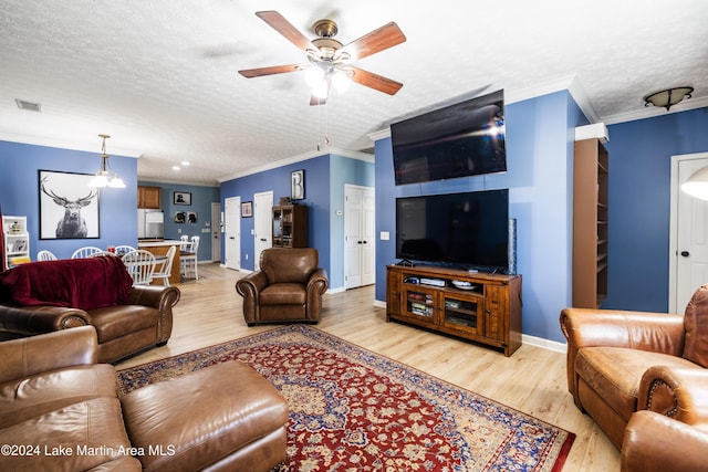 living room with ceiling fan with notable chandelier, wood-type flooring, a textured ceiling, and ornamental molding