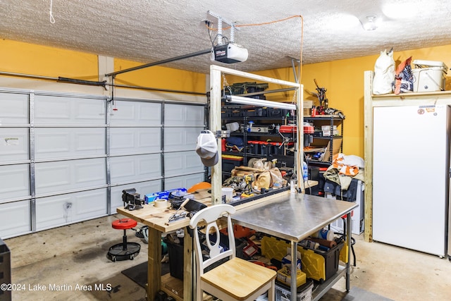 garage featuring white fridge and a garage door opener