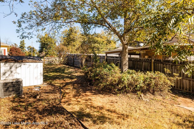 view of yard featuring a storage unit and cooling unit