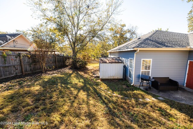 view of yard featuring a patio area and a storage shed