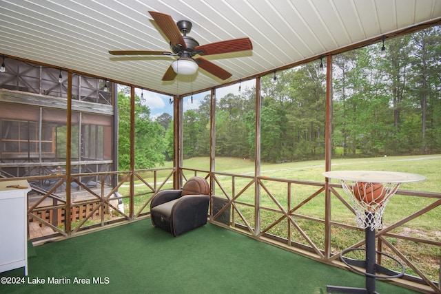 unfurnished sunroom featuring ceiling fan