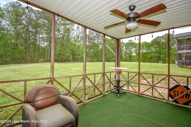 unfurnished sunroom with ceiling fan