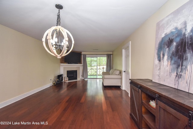 living room featuring an inviting chandelier and dark hardwood / wood-style flooring