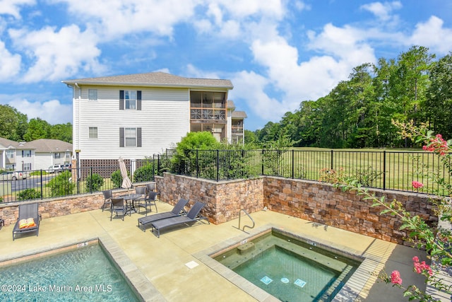 view of pool featuring a patio area and an in ground hot tub