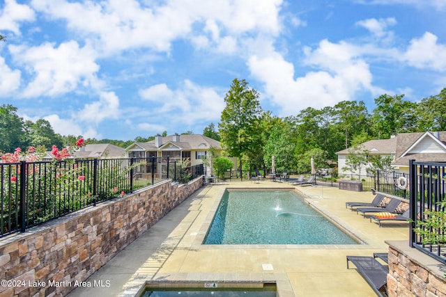 view of pool with a patio area and a jacuzzi