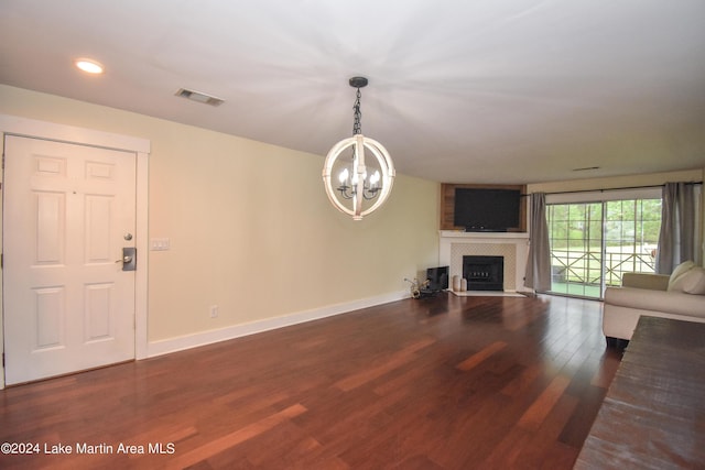 unfurnished living room featuring dark hardwood / wood-style floors and a chandelier