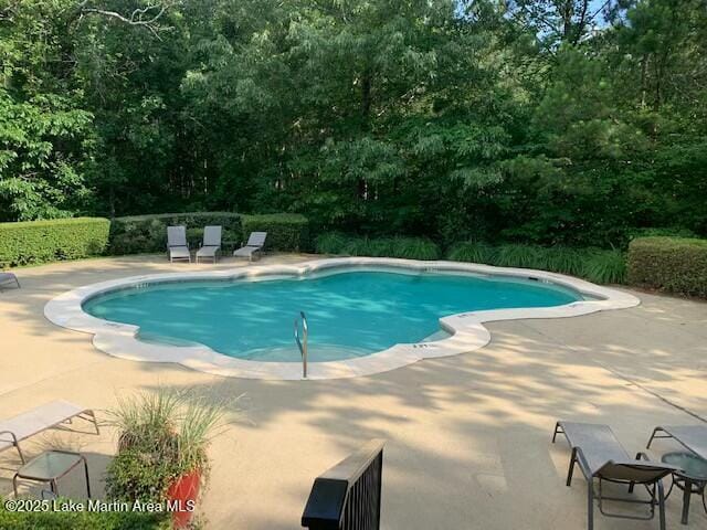 outdoor pool with a patio area