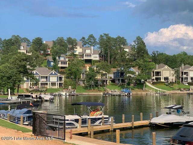 dock area featuring a residential view and a water view