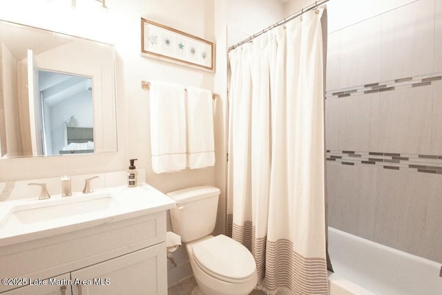 bathroom with shower / bath combination with curtain, vanity, and toilet