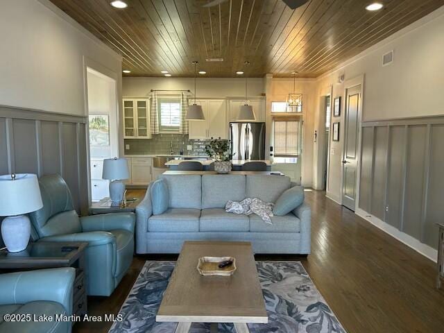 living room with wooden ceiling, recessed lighting, visible vents, wainscoting, and dark wood finished floors