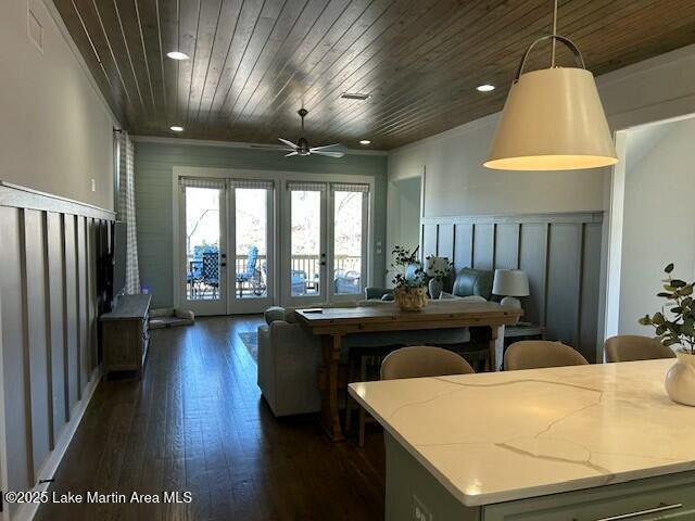 kitchen featuring recessed lighting, dark wood-type flooring, wood ceiling, open floor plan, and light stone countertops