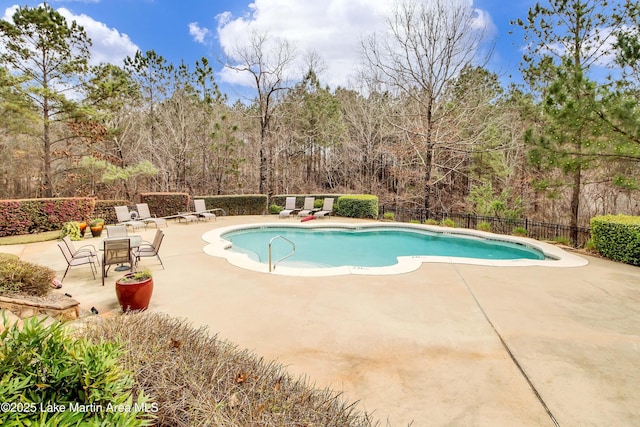 110 Village Loop Unit A103, Dadeville, AL 36853 - view of swimming pool with a patio area and view of wooded area