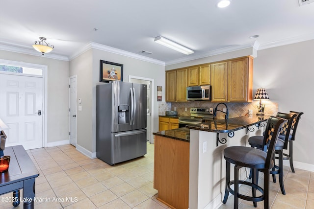 90 Crowne Pointe Rd, Dadeville, AL 36853 - kitchen with crown molding, a peninsula, brown cabinets, stainless steel appliances, and visible vents