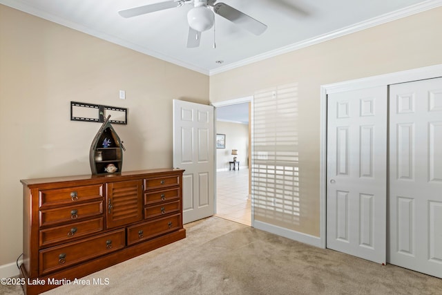 90 Crowne Pointe Rd, Dadeville, AL 36853 - bedroom featuring a closet, baseboards, ornamental molding, a ceiling fan, and light carpet