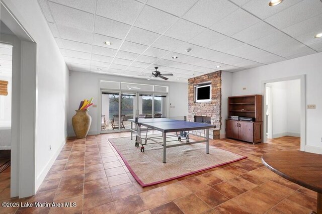 1689 River Oaks Dr, Jacksons Gap, AL 36861 - rec room featuring a stone fireplace, baseboards, a ceiling fan, a paneled ceiling, and recessed lighting
