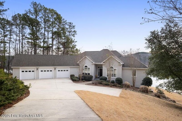 1689 River Oaks Dr, Jacksons Gap, AL 36861 - view of front of property featuring driveway, a garage, and stucco siding