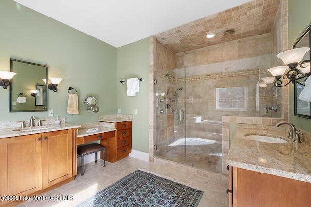 1689 River Oaks Dr, Jacksons Gap, AL 36861 - bathroom with a shower stall, two vanities, tile patterned flooring, and baseboards