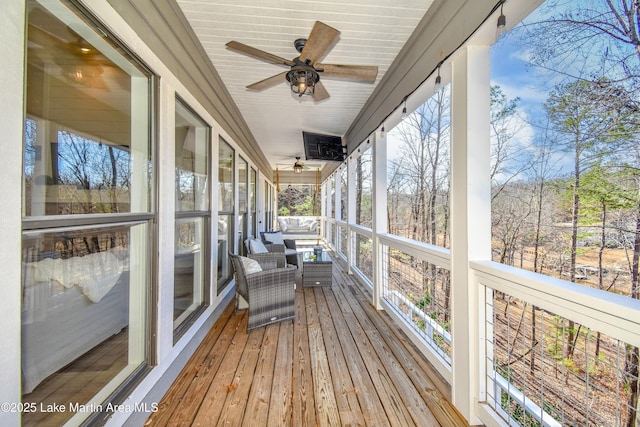 unfurnished sunroom featuring ceiling fan