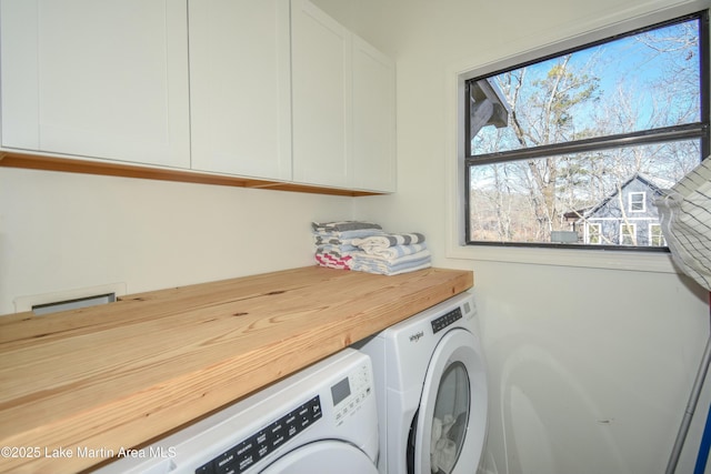 laundry area featuring cabinets and washing machine and dryer