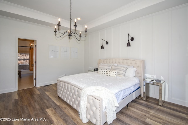 bedroom featuring a chandelier, dark wood-type flooring, and ornamental molding